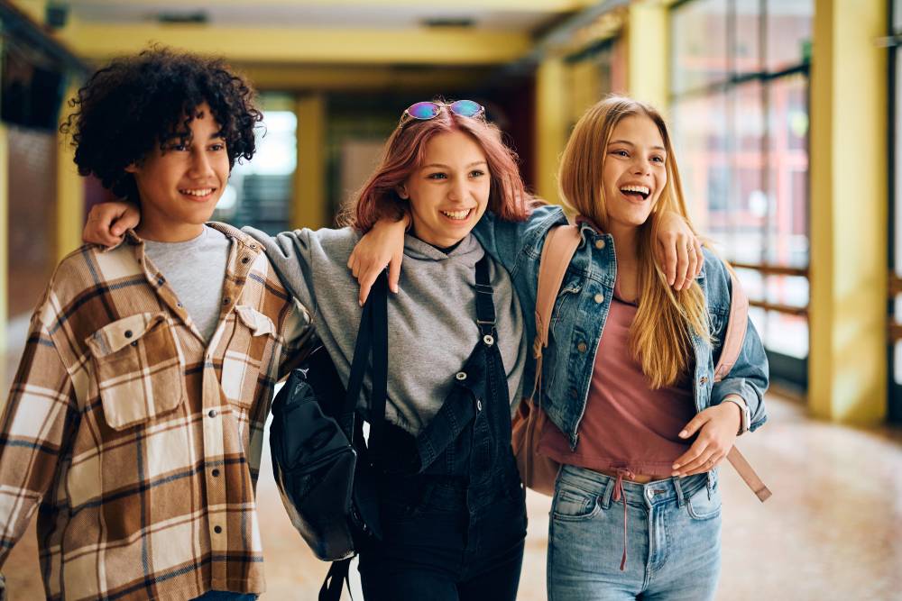 Teens walking together arm in arm